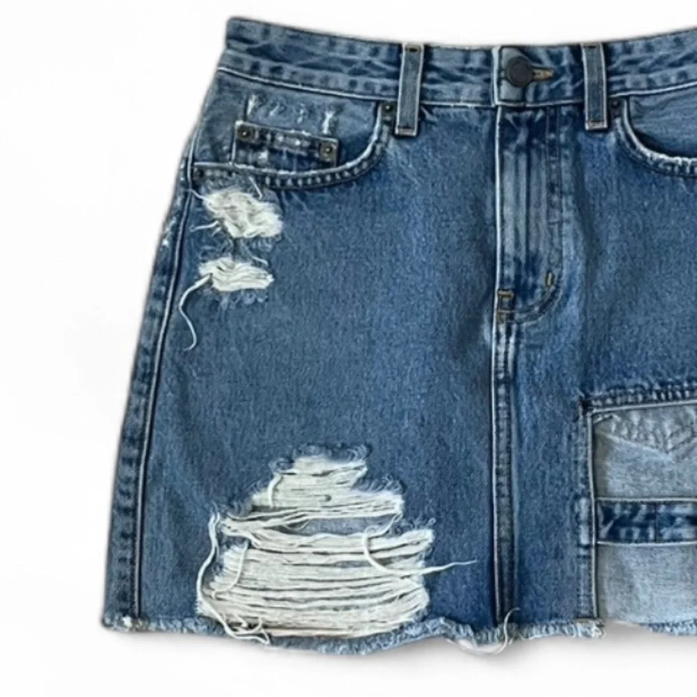 Carmar Los Angeles blue denim buckle cutout mini skirt, size 25. Distressed.